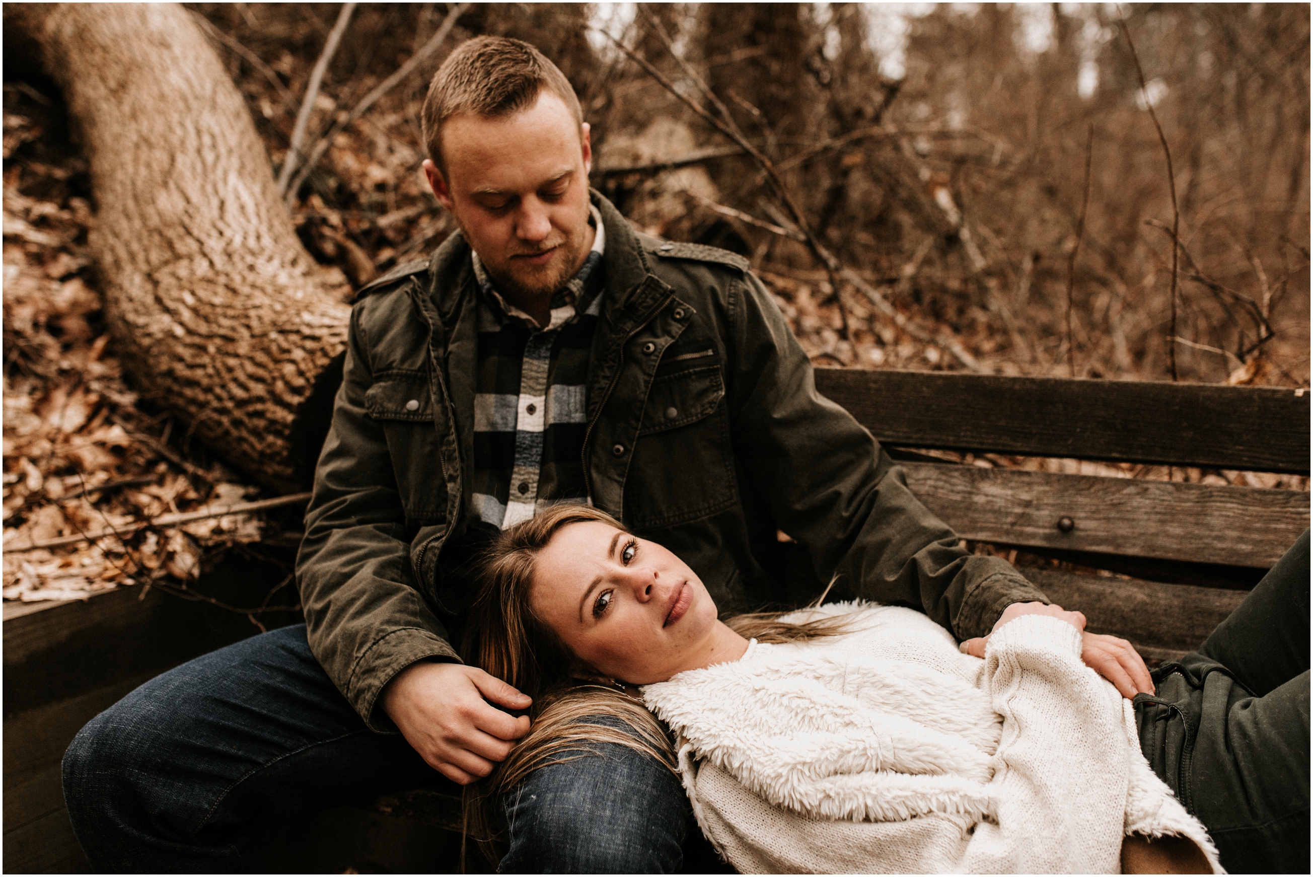 girl lying on bench and resting head on guy's lap