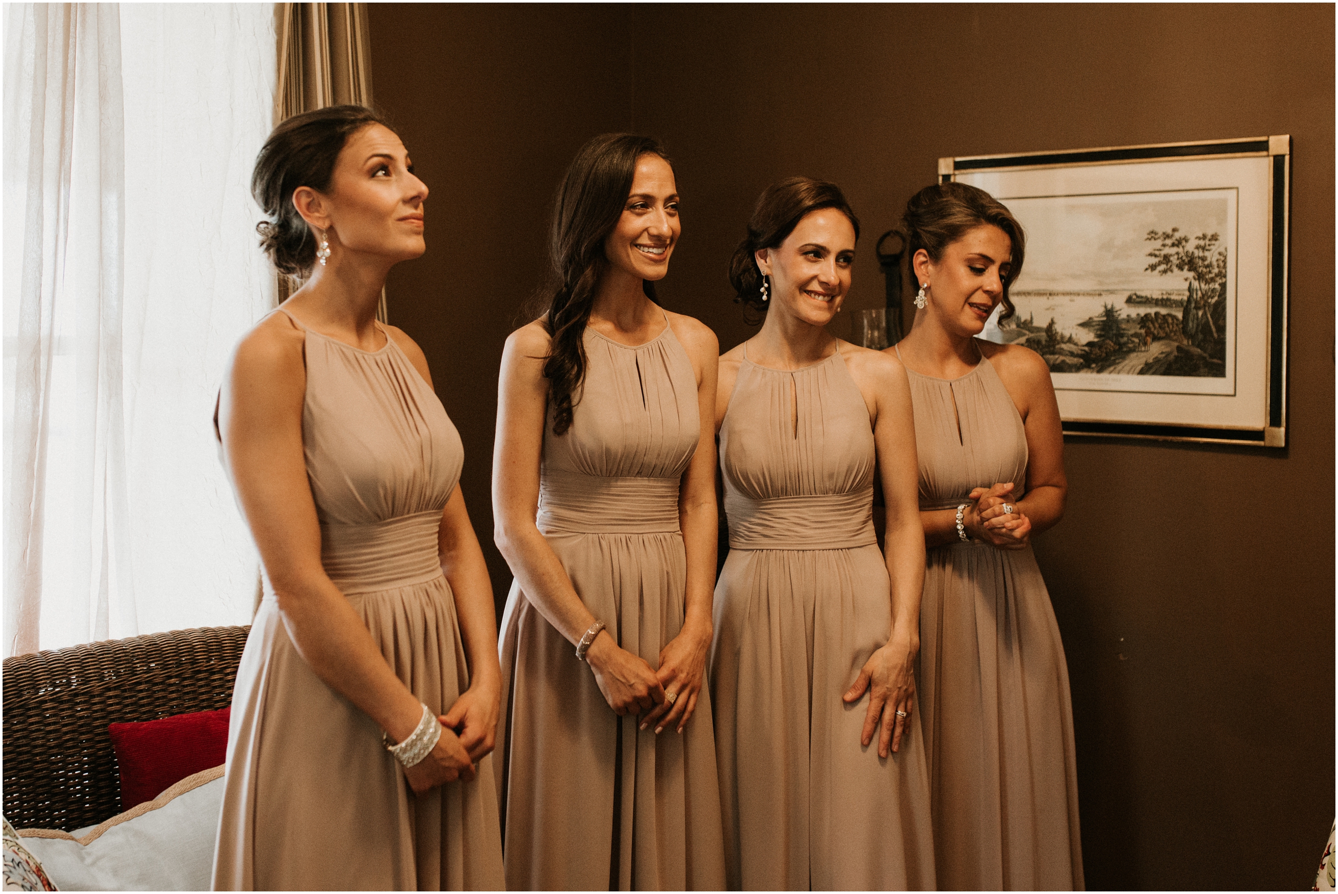 bridesmaids waiting for bride to reveal her wedding dress