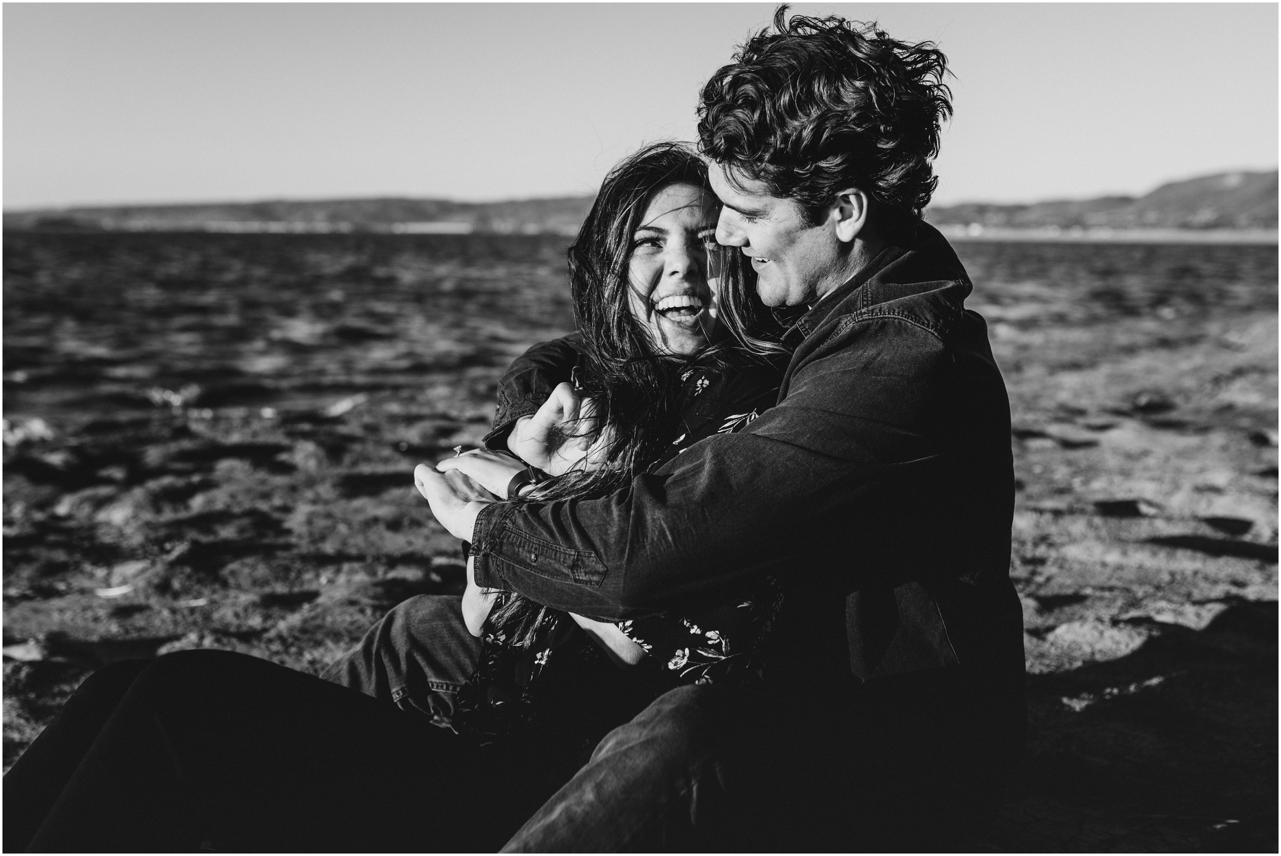 couple laughing at sunset on windy beach in bay area california