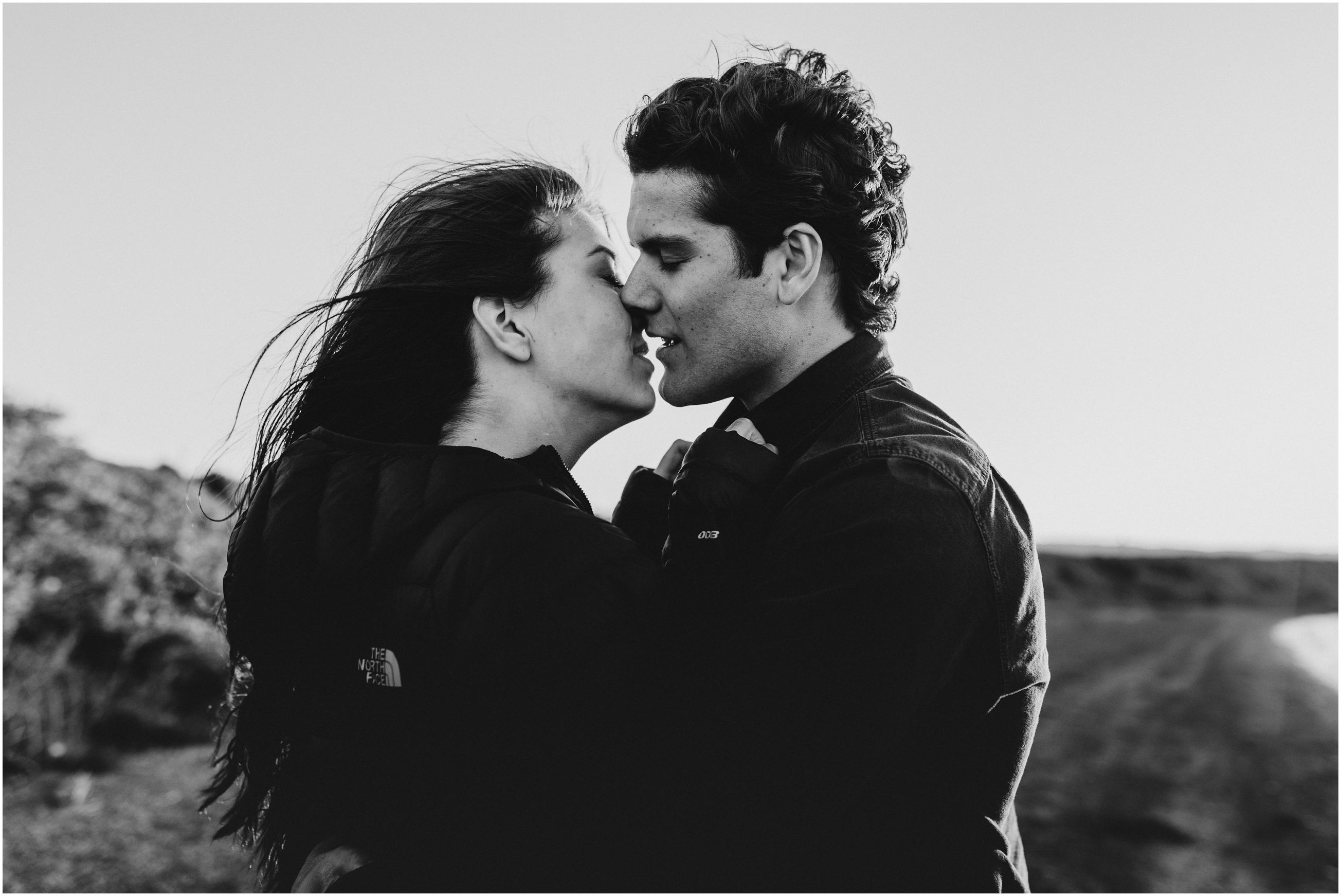 black and white couple seconds before kissing on beach in bay area california