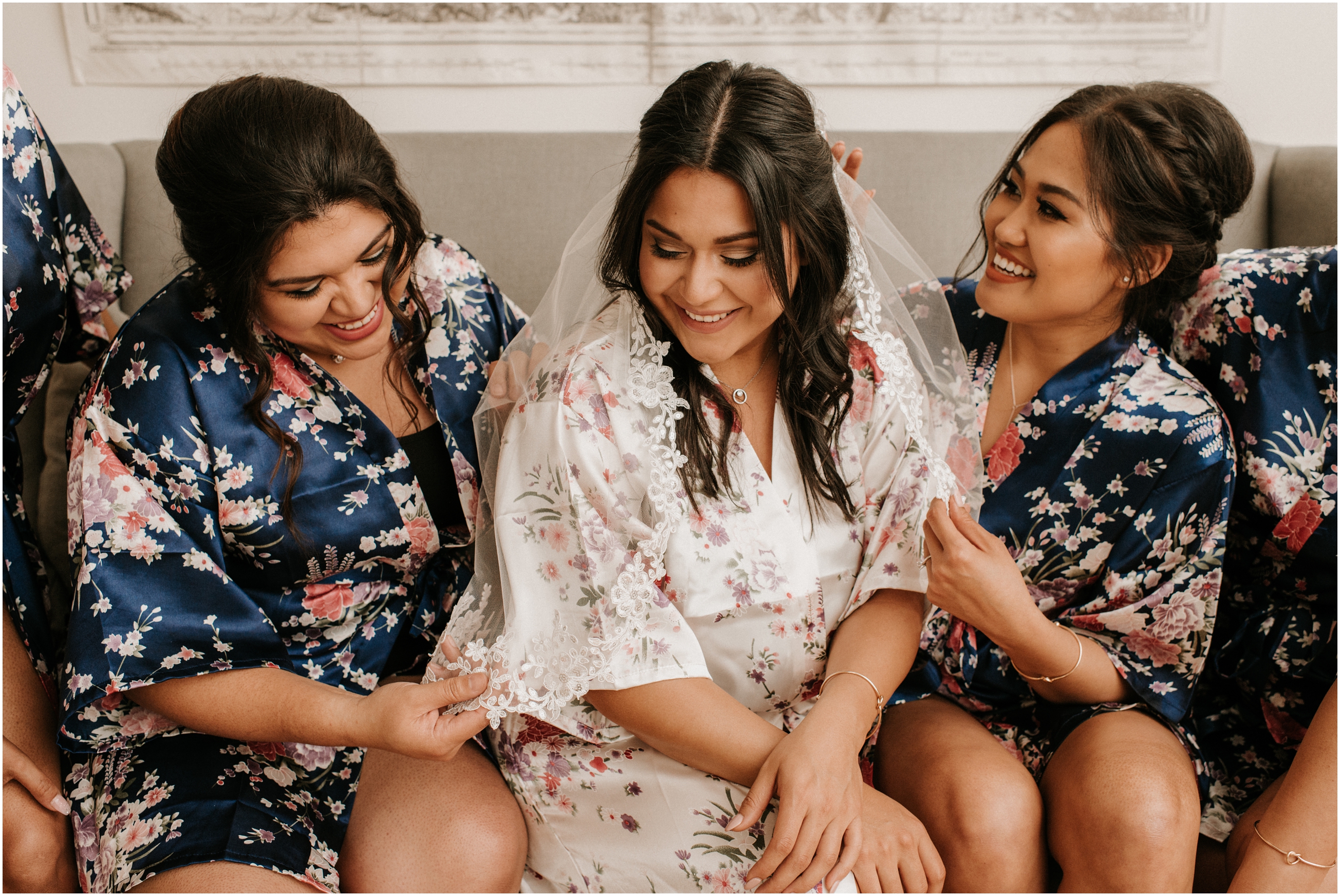 bride and bridesmaids laughing in matching floral robes