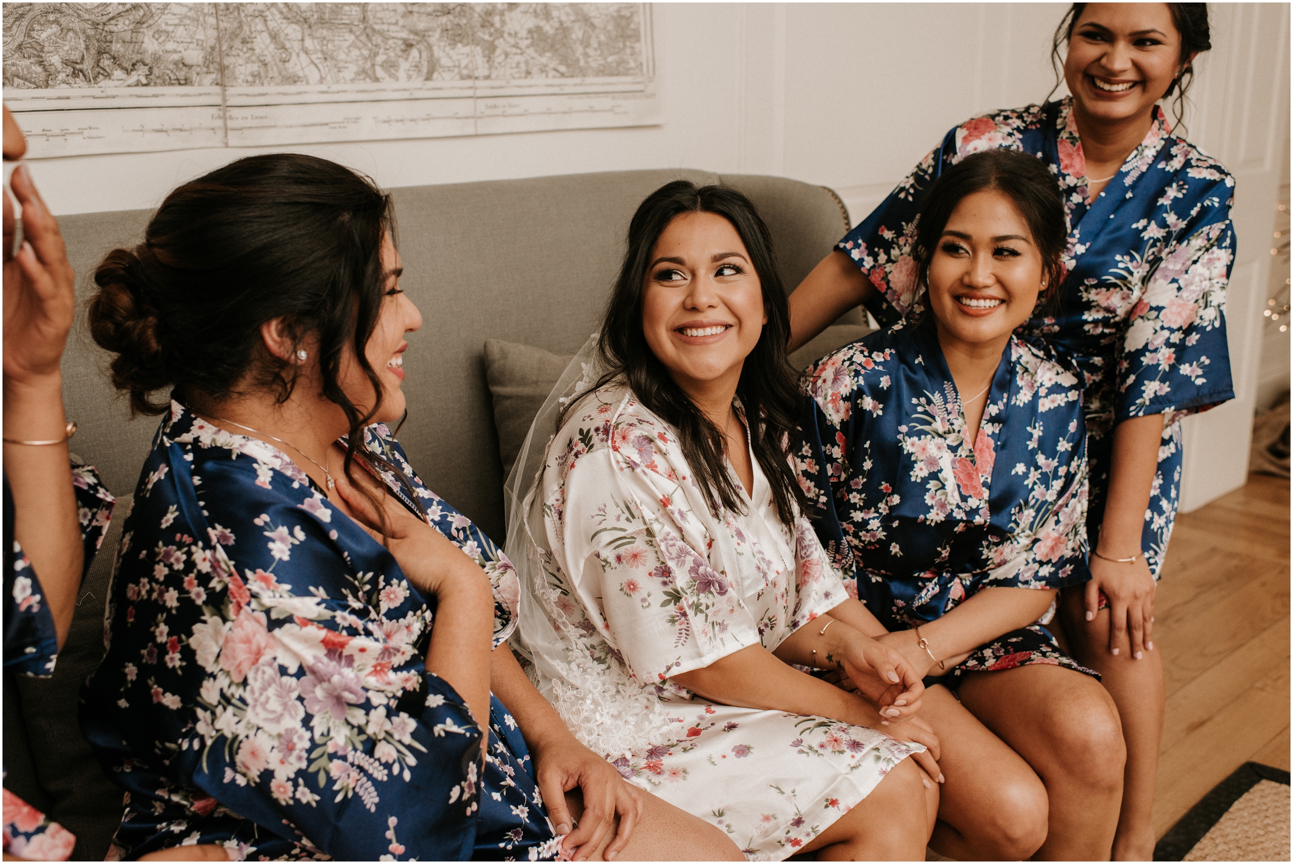 bridesmaid's in matching robes laughing together