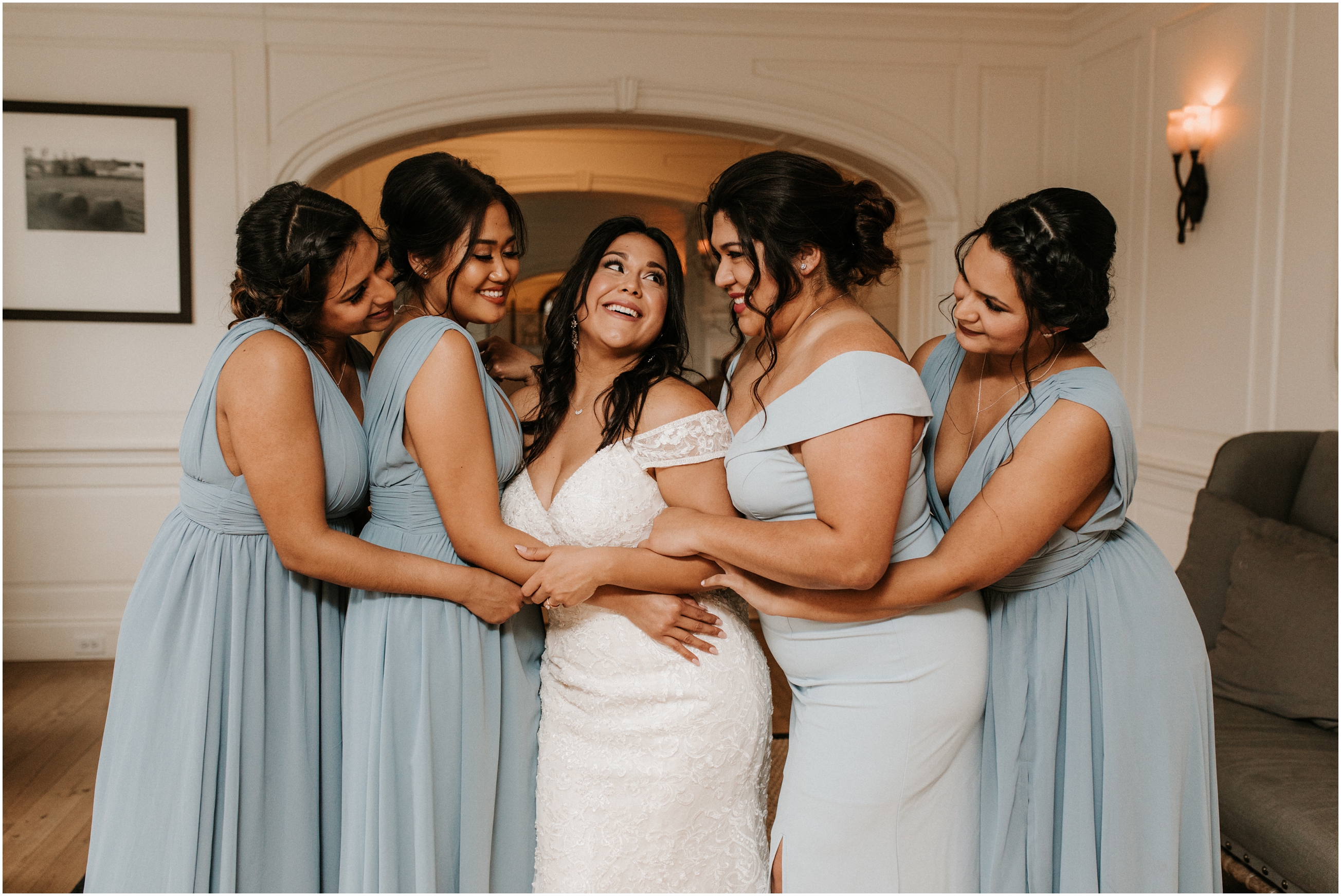 bridesmaid's in blue gowns laughing with each other