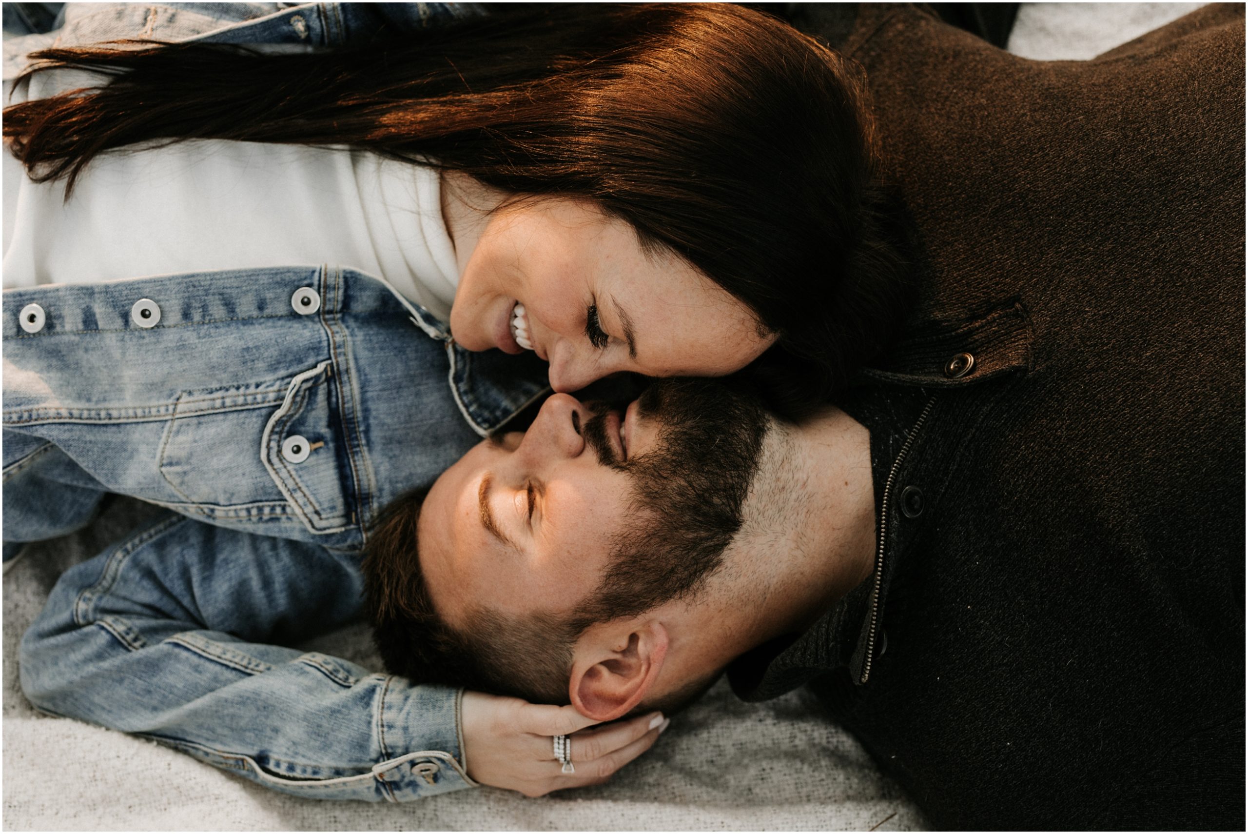 overhead photo of couple lying down and snuggling