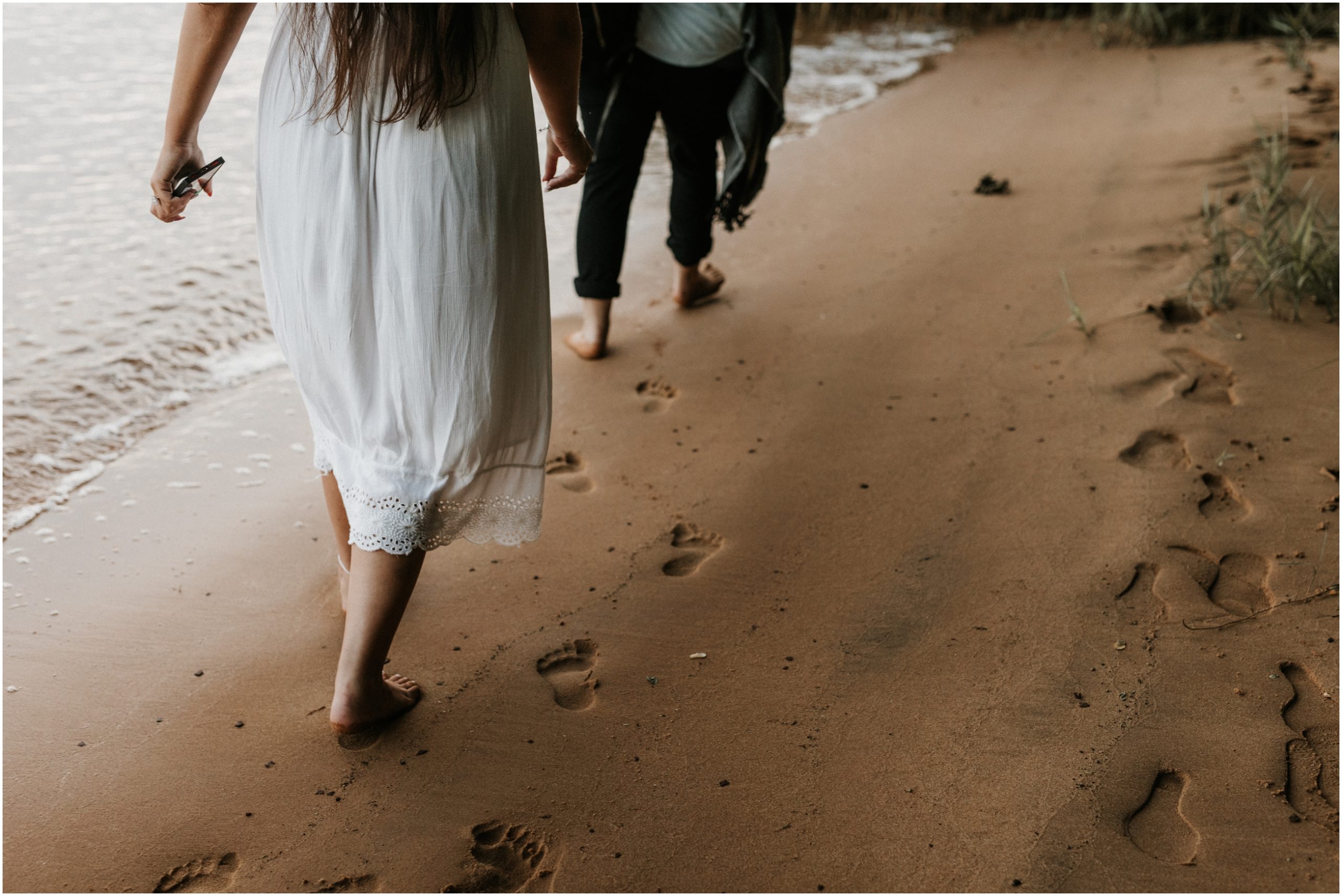 feet imprints in sand walking