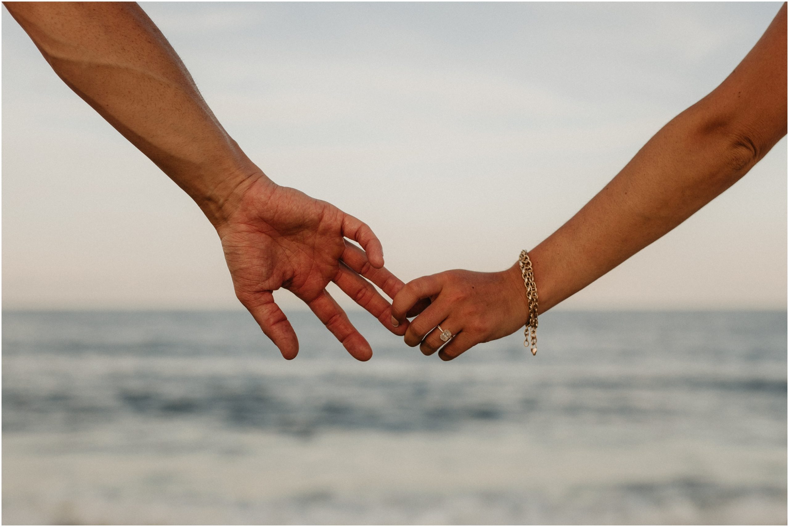 hands holding on beach