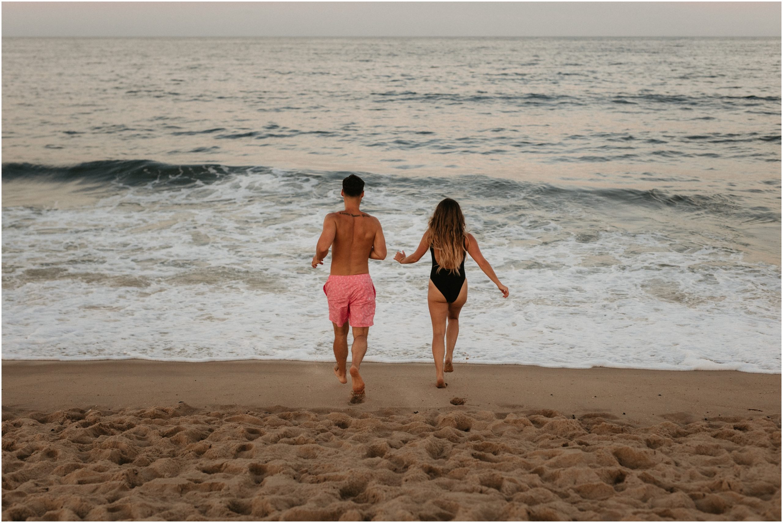 man and woman holding hands running into ocean in new jersey