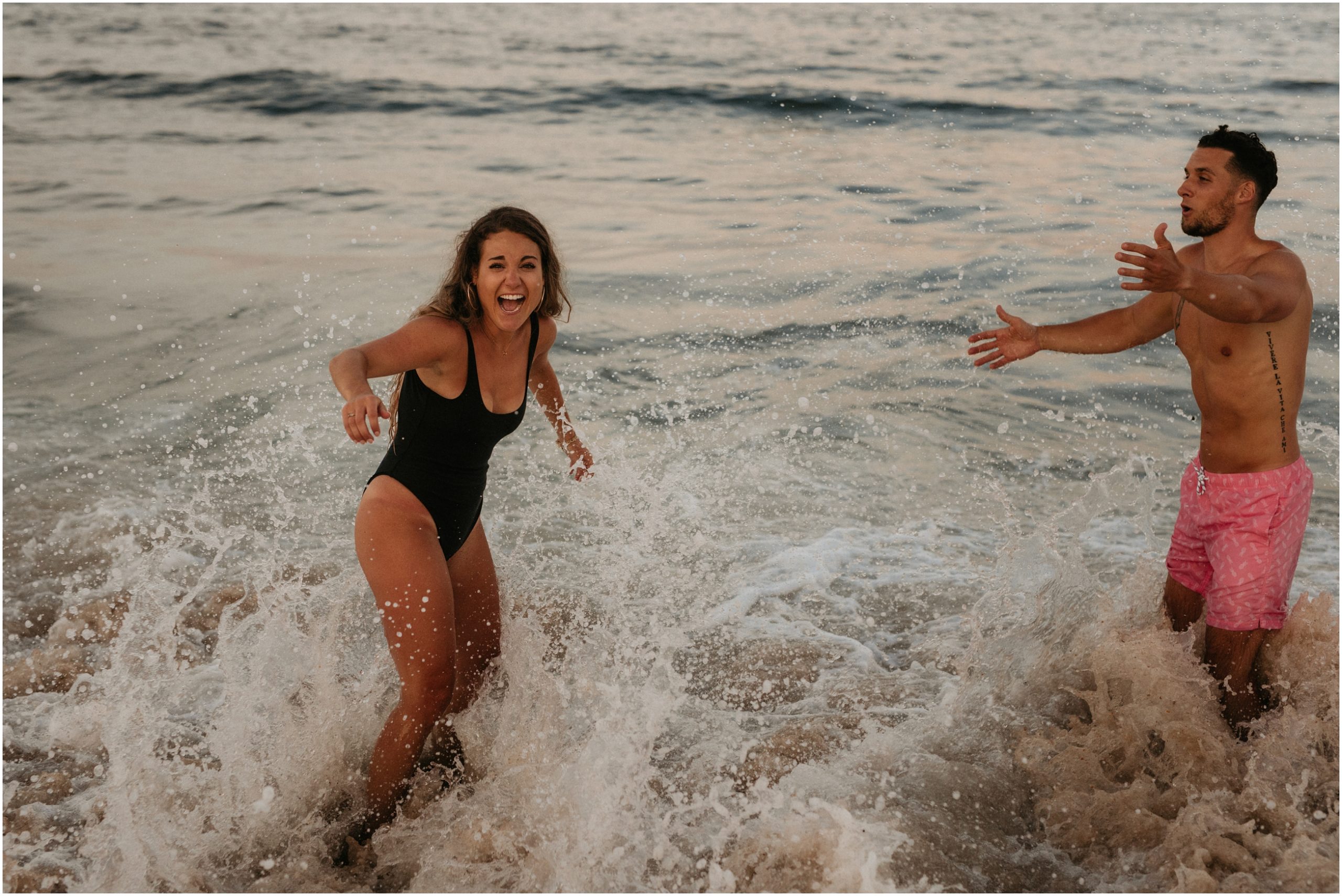 man and woman playing in ocean in new jersey