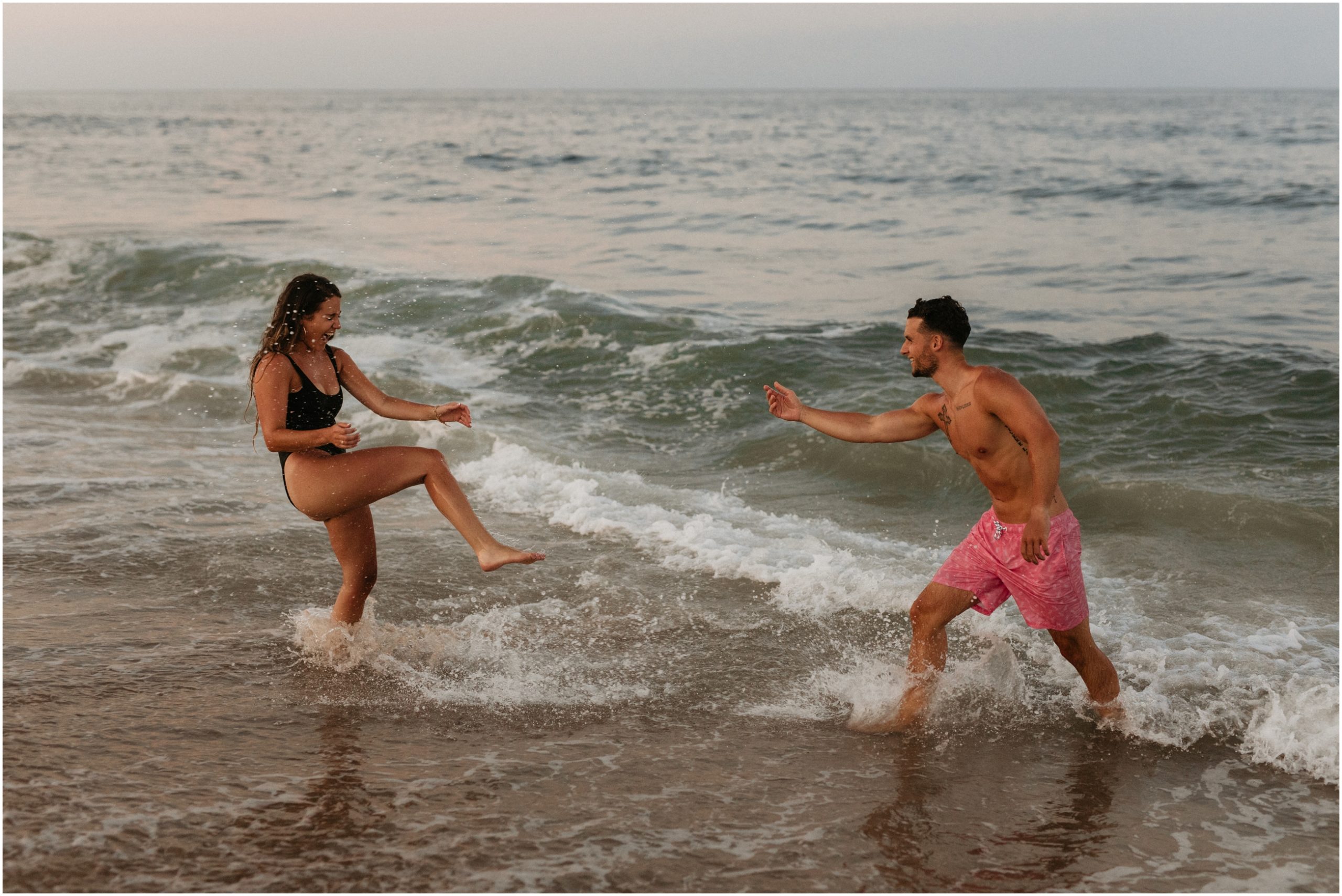couple playing in ocean