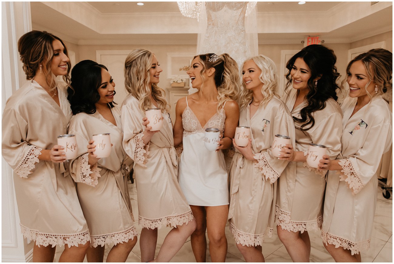 bridesmaids in matching robes with monogrammed wine cups