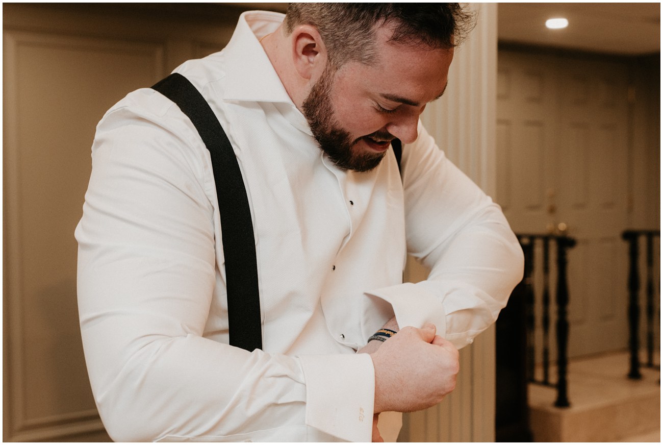 groom adjusting cufflinks