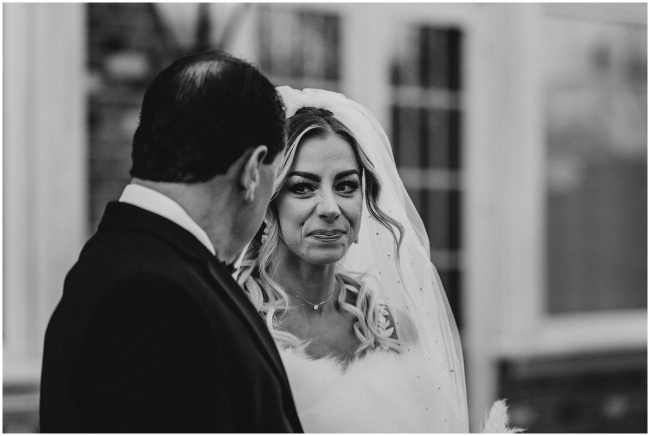bride looking at father with tears in eyes