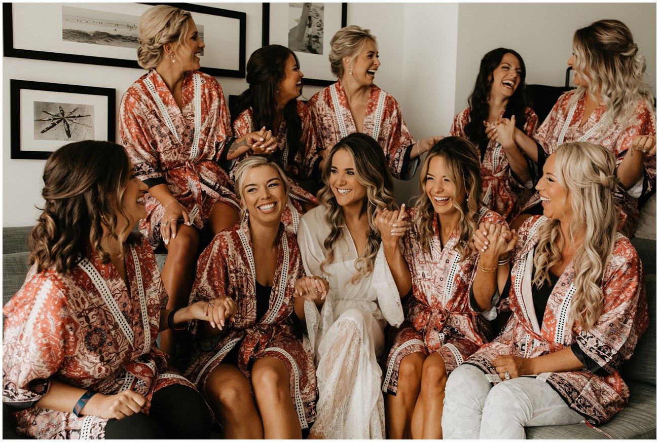 bride and bridesmaids dancing in matching robes