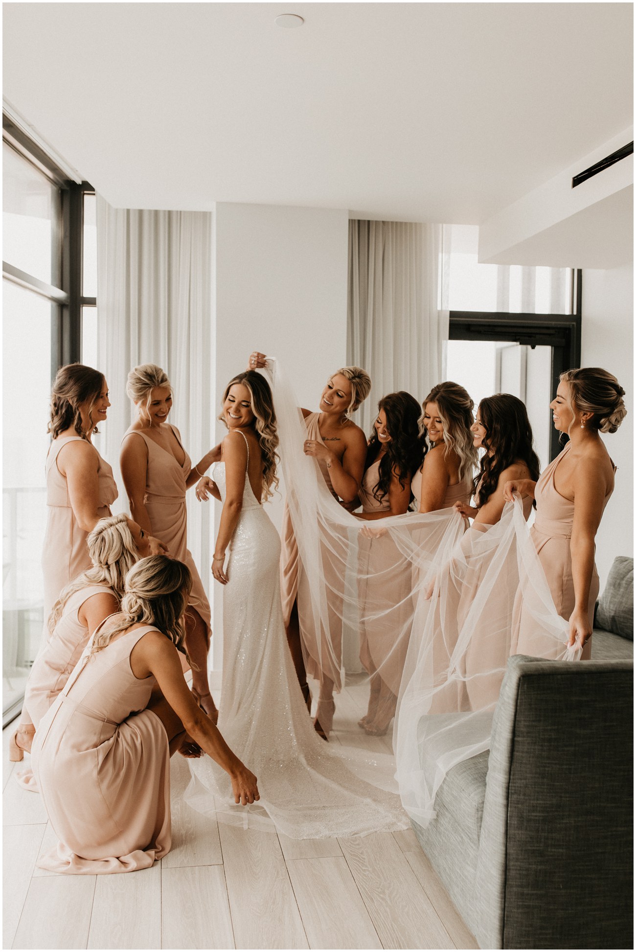 bridesmaids fluffing and primping bride at Wave Resort in Long Branch NJ