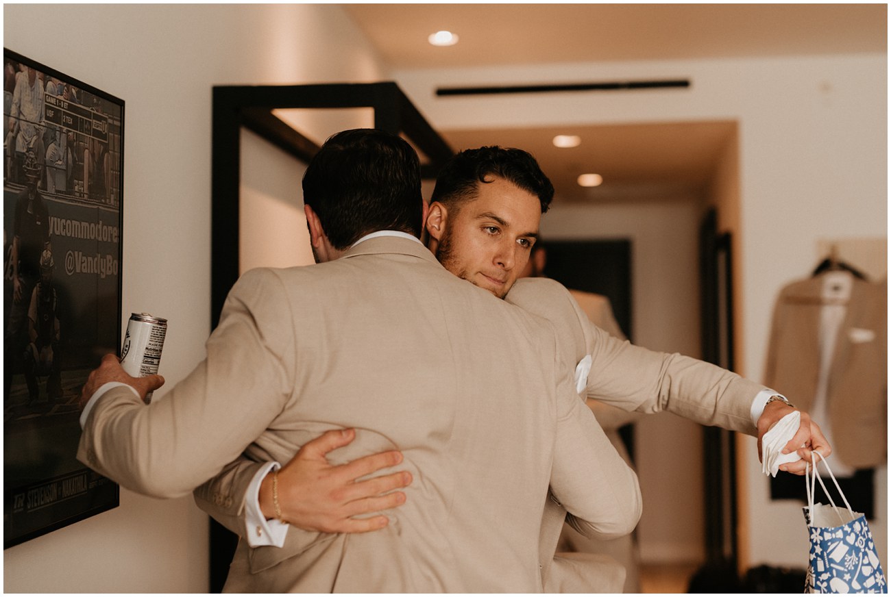 groom hugging friend