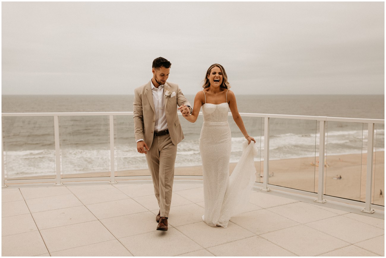 bride and groom walking on balcony of Wave Resort in Long Branch, NJ