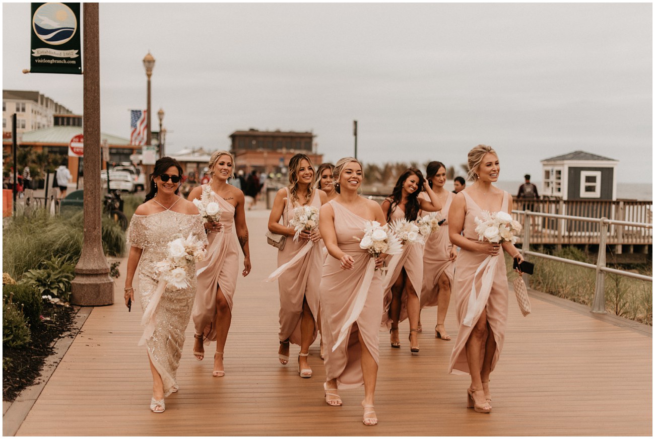 bridesmaids walking on boardwalk in Long Branch, NJ