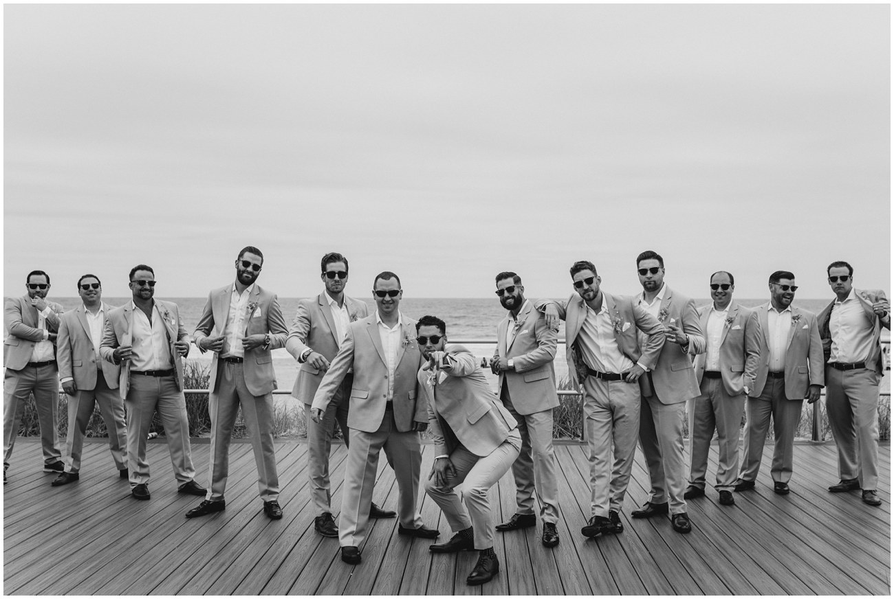 black and white portrait of groomsmen on boardwalk at Wave Resort in Long Branch, NJ