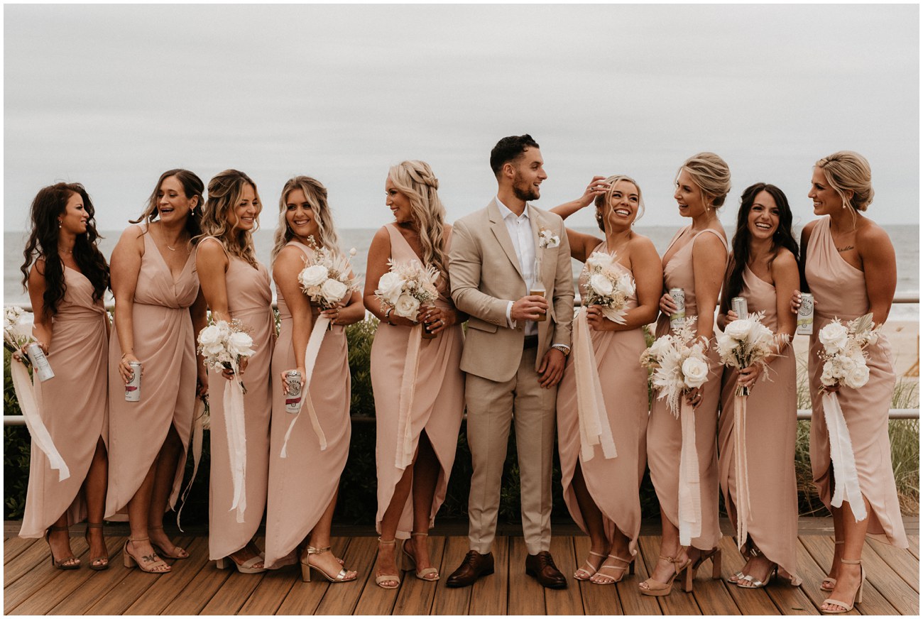 groom with bridesmaids on boardwalk at Wave Resort in Long Branch, NJ