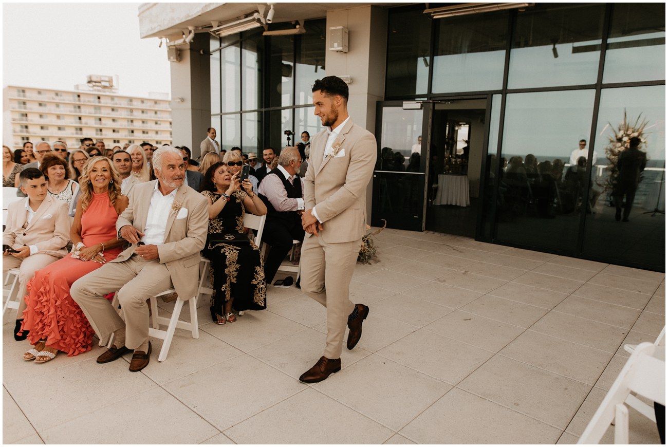 groom walking down aisle during ceremony at wave resort in new jersey