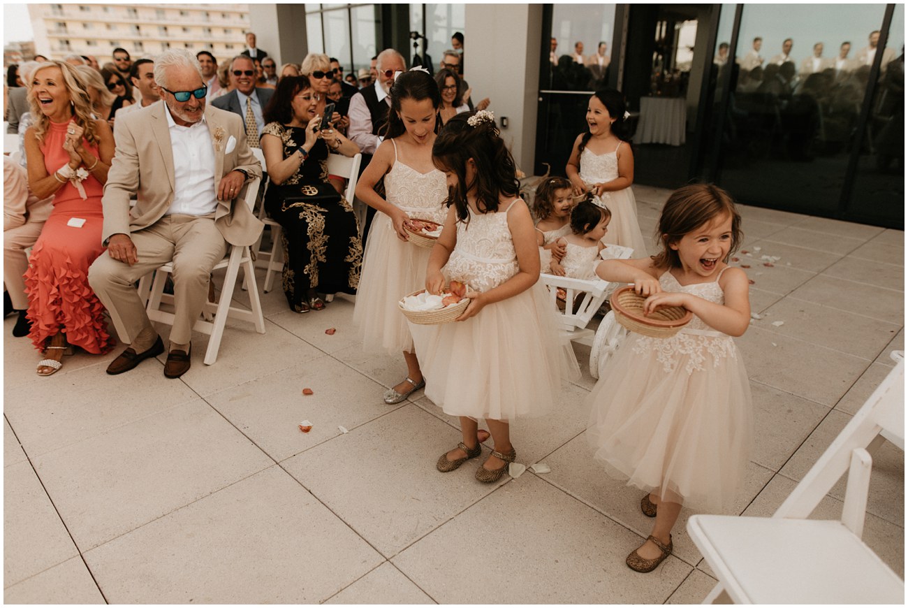 flower girls walking down aisle during ceremony at wave resort in new jersey