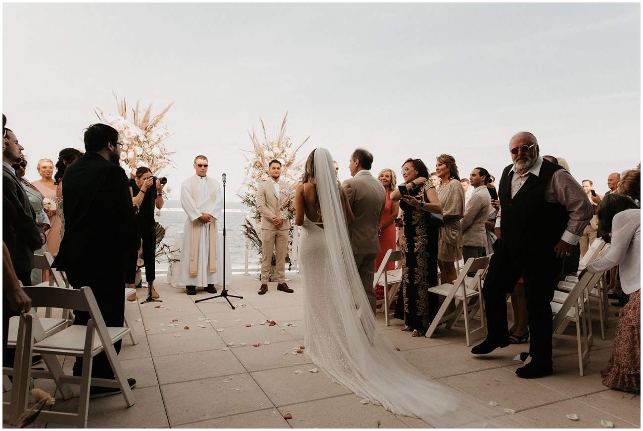 bride and father walking down aisle during ceremony at wave resort in new jersey