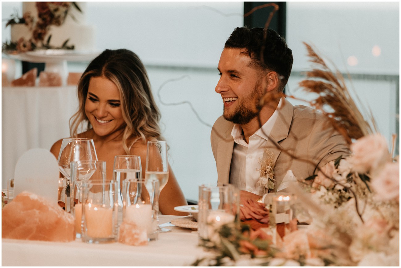 couple laughing during toasts at reception at wave resort in long branch new jersey