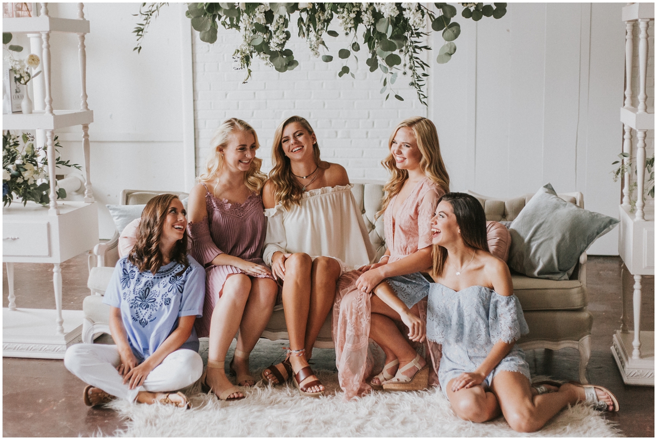 high school senior girls laughing pastel colors florals indoor session