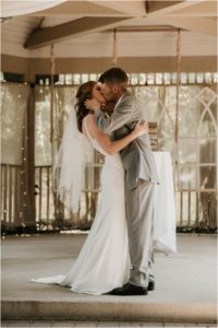 bride and groom first kiss at ceremony
