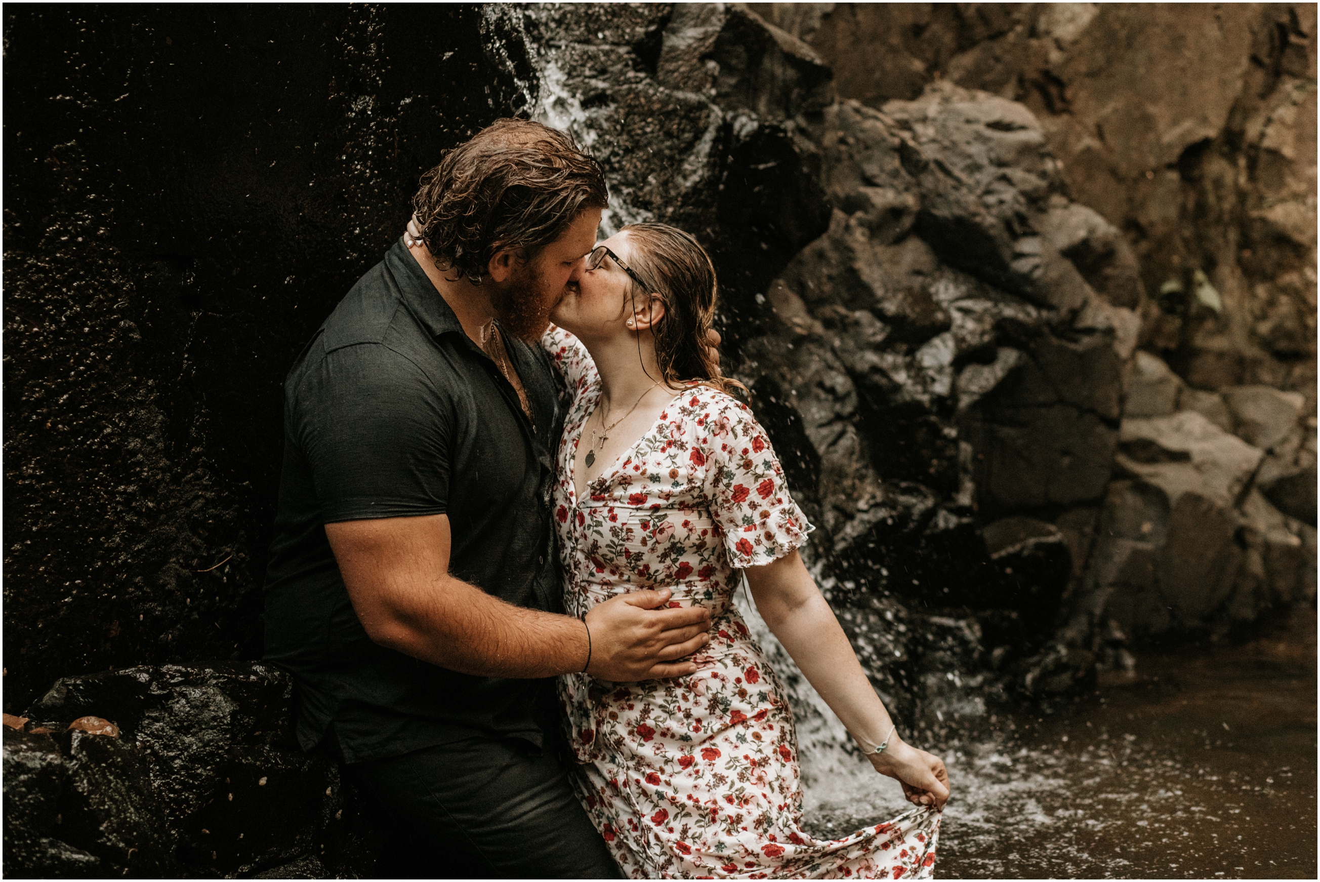 couple kissing in waterfall