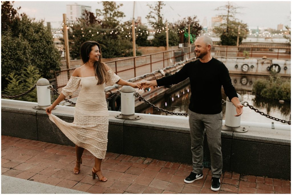 Man and woman share a dance on bridge for Philadelphia engagement session