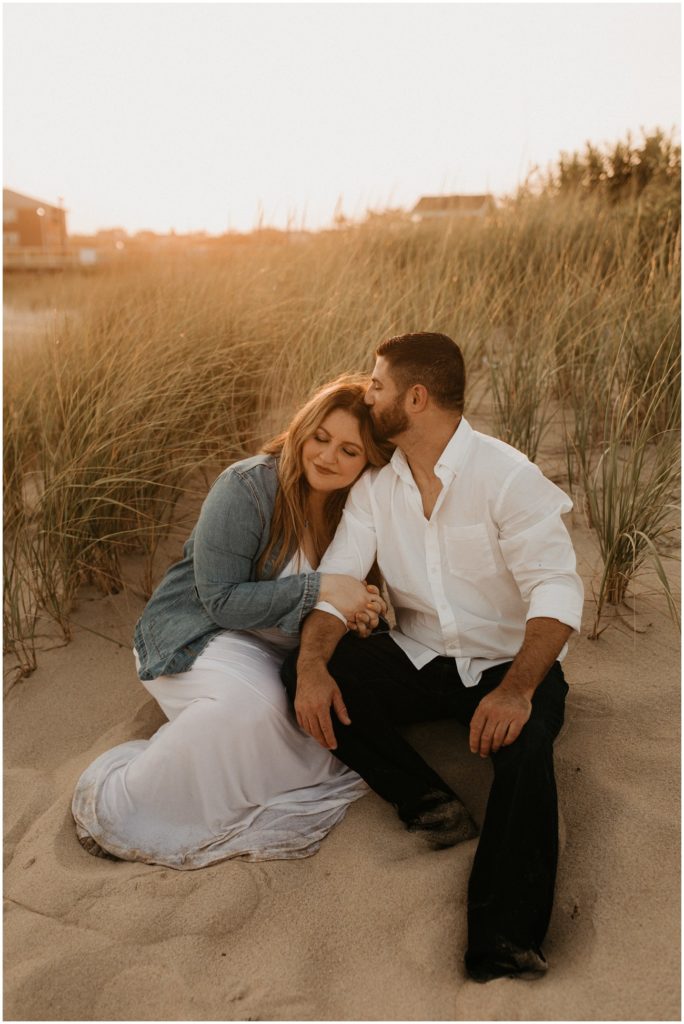 Couple embraces on the dunes for Ocean Grove engagement session