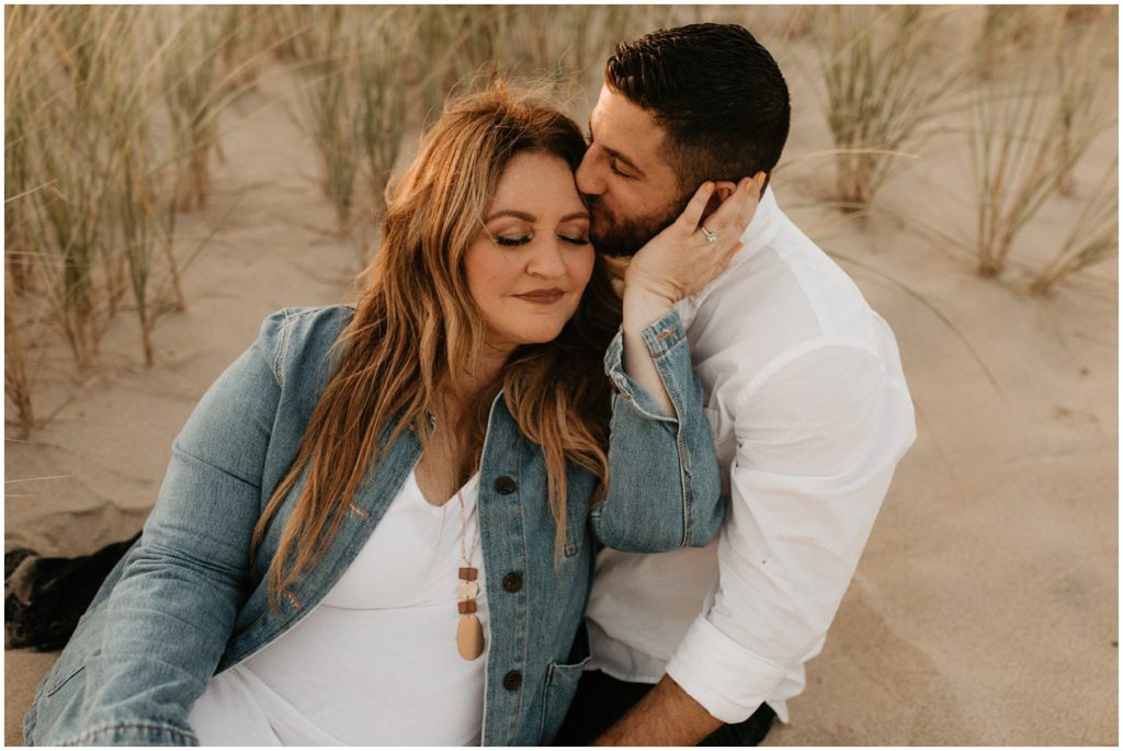 Couple embraces on the dunes for Ocean Grove engagement session