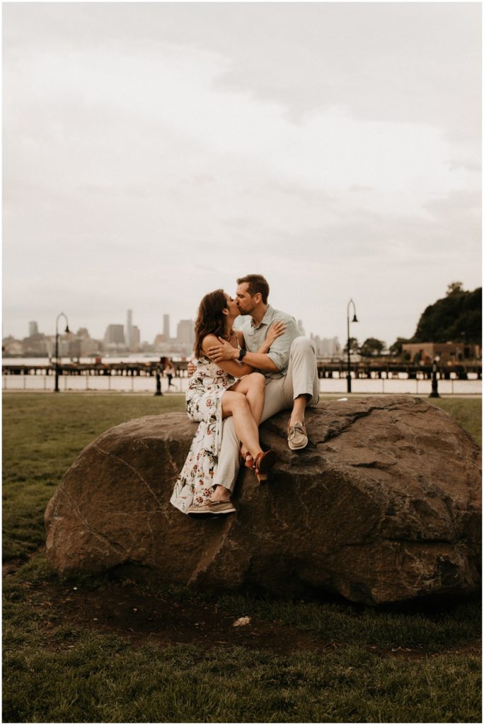 couple shares a kiss in Hoboken park